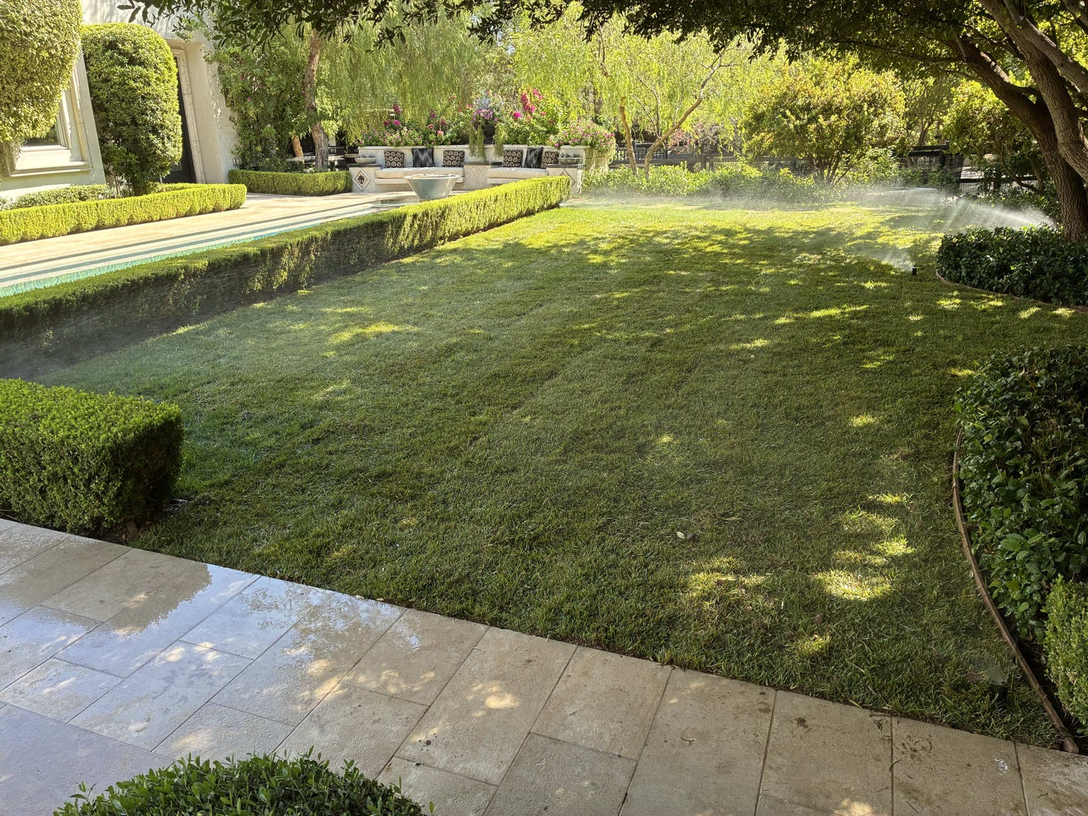Freshly maintained estate lawn with irrigation running