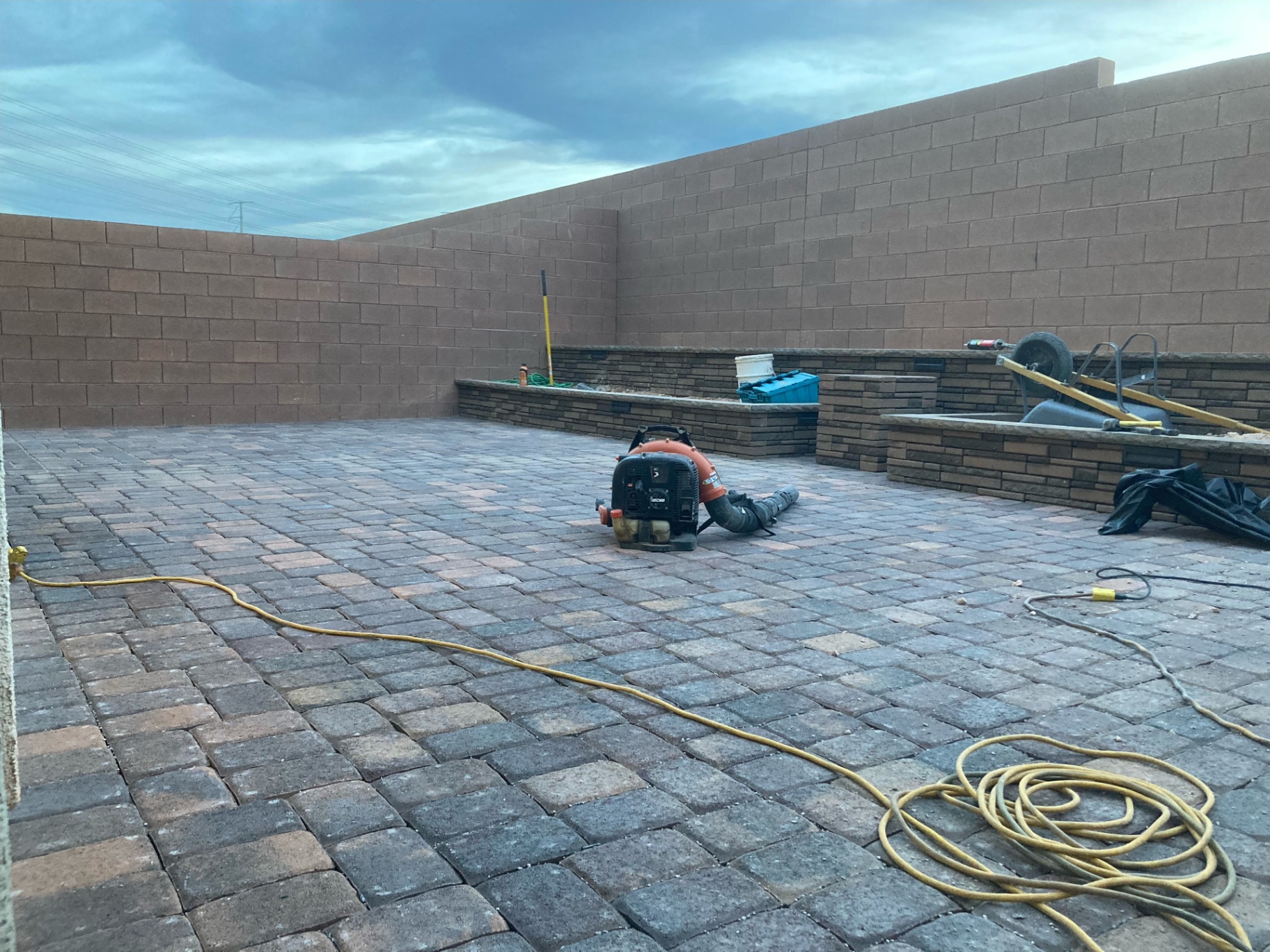 Large paver patio with stacked-stone retaining planter wall