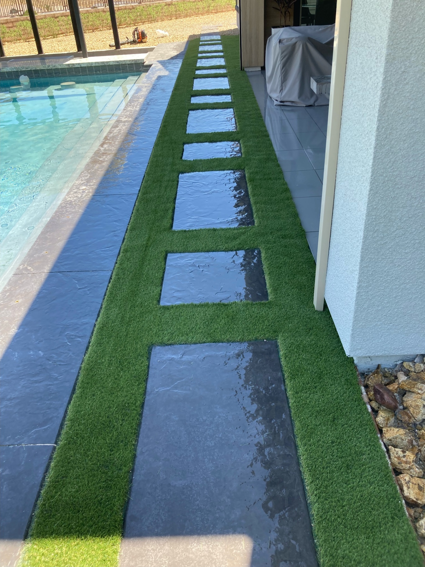 Poolside walkway with turf, slate steppers and clean modern lines