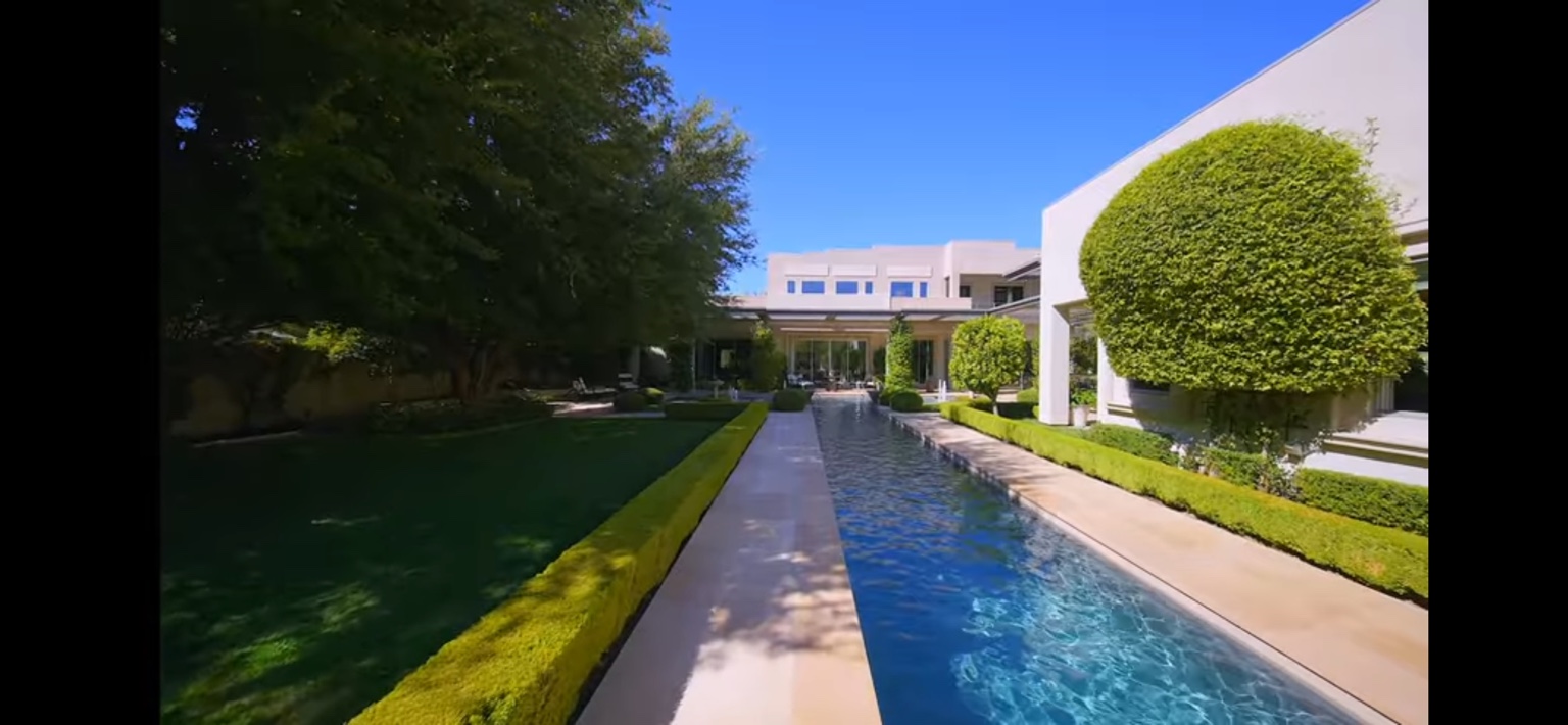 Formal lawn and long reflecting pool at a maintained estate