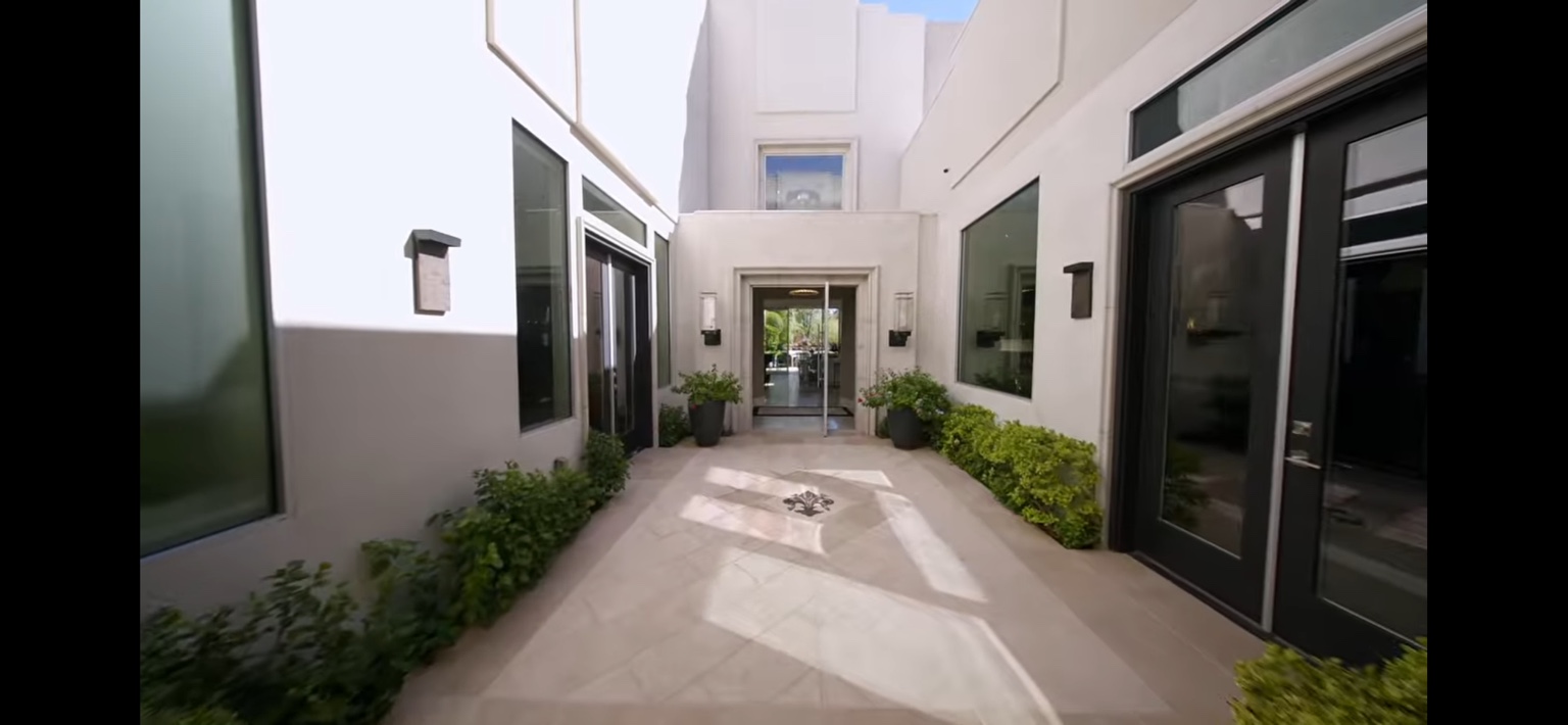 Bright estate courtyard with neatly maintained foundation plantings